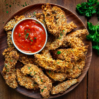 Plate of Portobello Mushroom Fries on a wooden table from overhead.