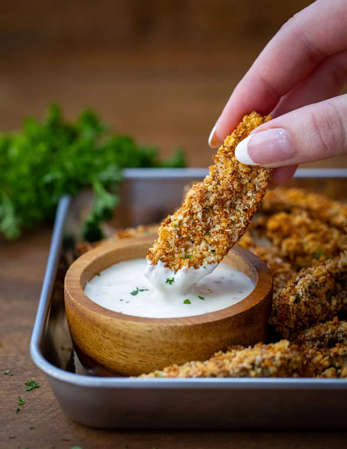 Dipping a Portobello Mushroom Fry into ranch dressing.