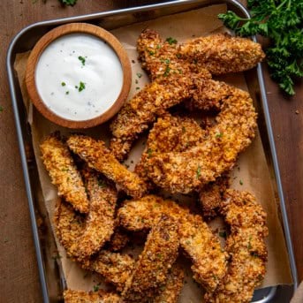 Small tray of Portobello Mushroom Fries on a wooden table with ranch from overhead.