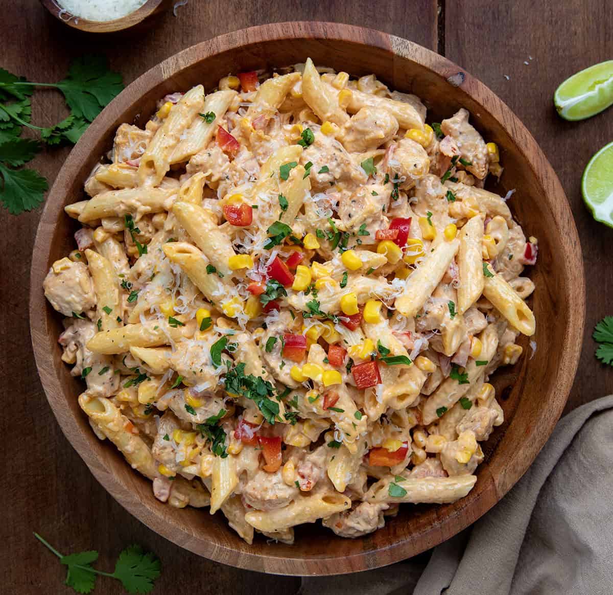 Bowl of Sriracha Chicken Pasta Salad on a wooden table from overhead.