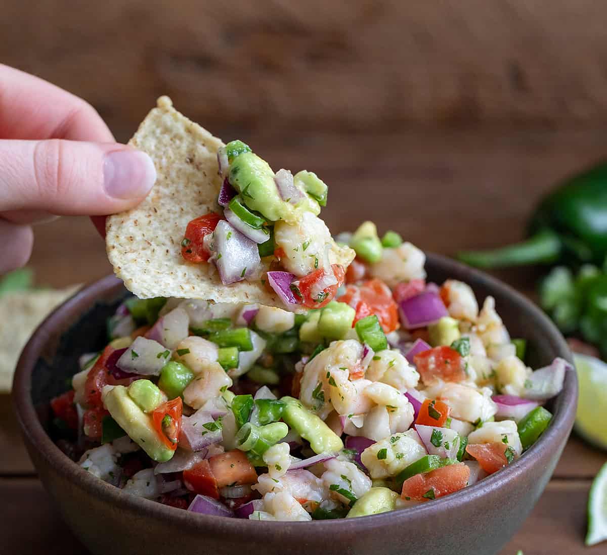 Dipping a chip into Avocado Shrimp Ceviche.