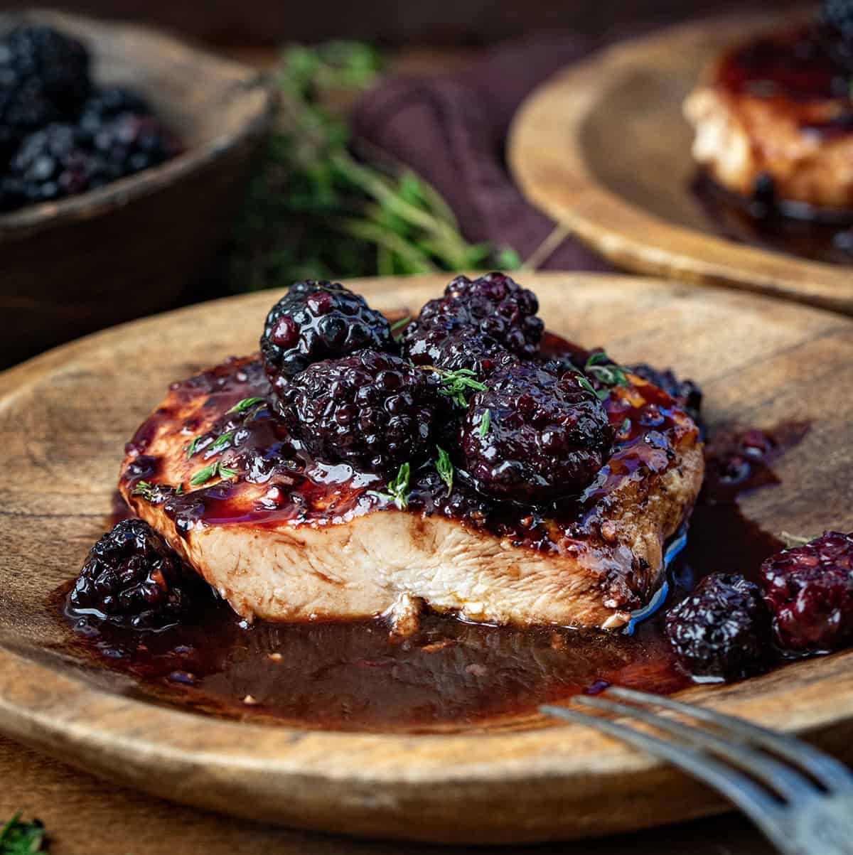 Piece of Bourbon Blackberry Chicken cut in half showing tender juicy chicken.