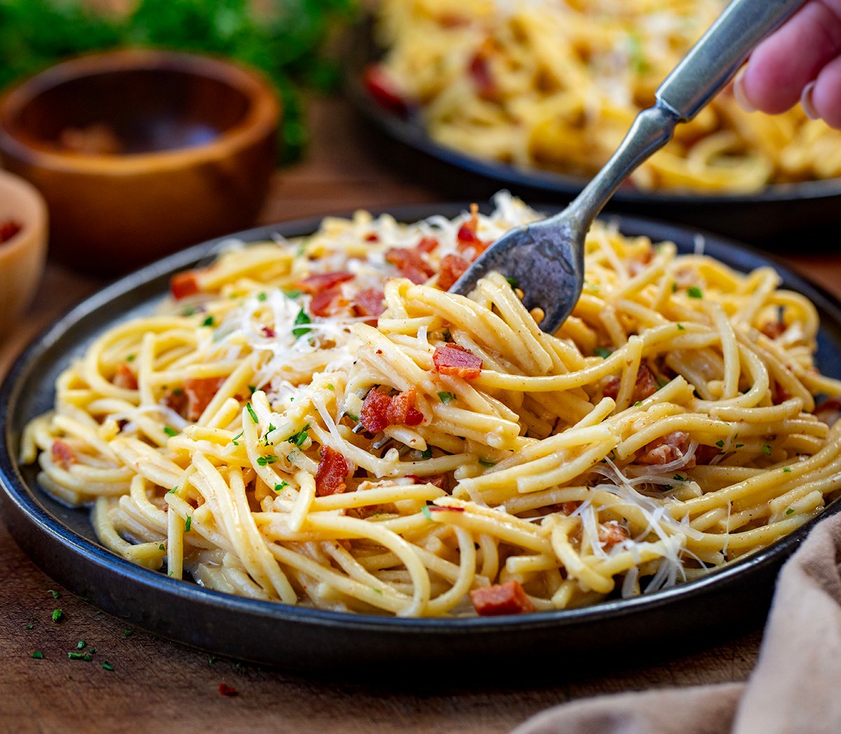 Plate of Chipotle Bacon Carbonara with a fork swirling the pasta.