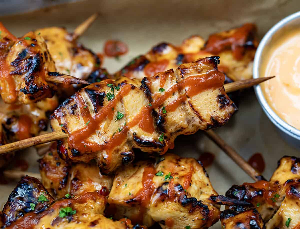 Close up of Chipotle Bang Bang Chicken Skewers in a tray.