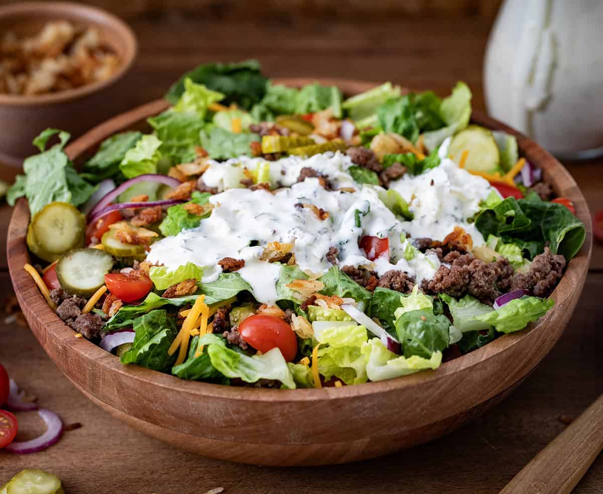 Crispy Rice Cheeseburger Salad in a bowl with dill pickle ranch dressing on it.