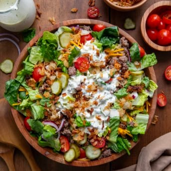 Bowl of Crispy Rice Cheeseburger Salad on a wooden table from overhead.