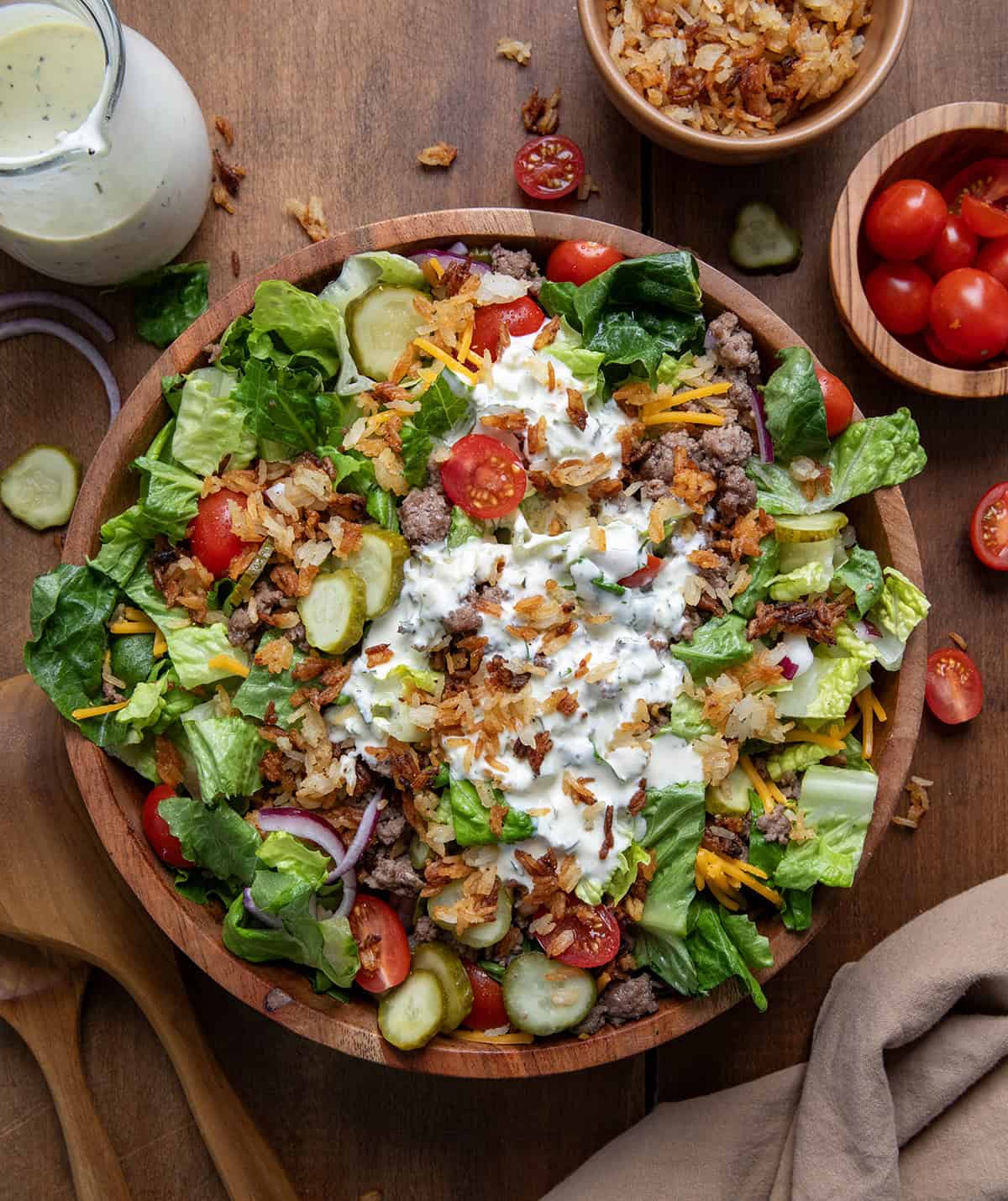 Bowl of Crispy Rice Cheeseburger Salad on a wooden table from overhead.