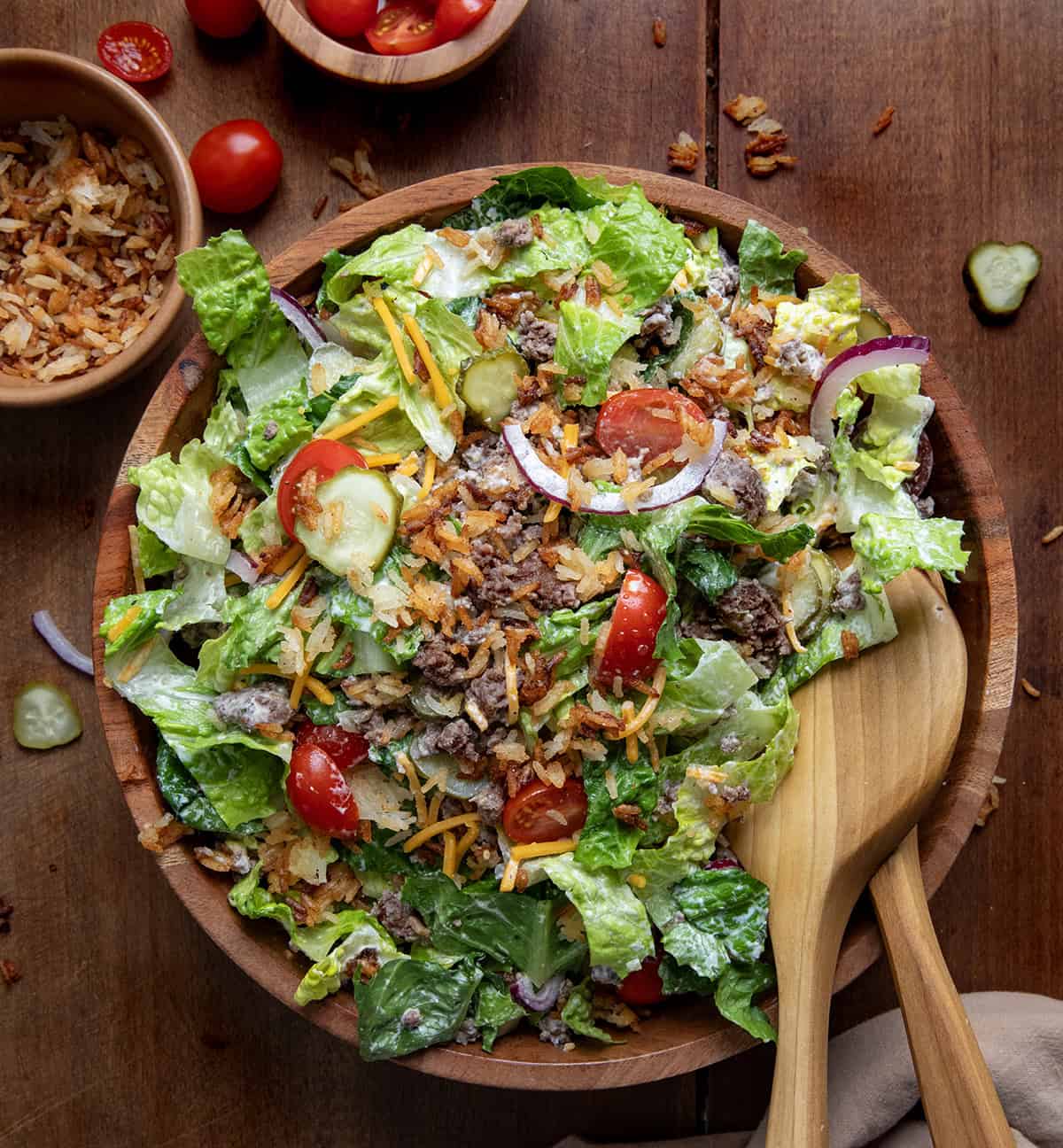 Bowl of Crispy Rice Cheeseburger Salad on a wooden table from overhead.