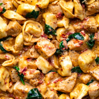 Close up of Tuscan Chicken Tortellini showing in detail the chicken and tortellini.