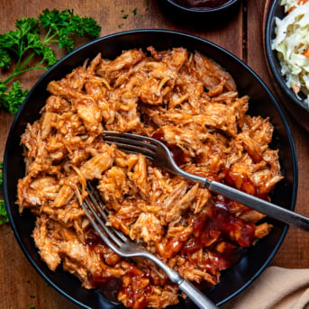 Two Ingredient Pulled Pork in a bowl with two forks in it from overhead.