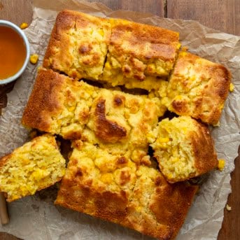 Cornbread Butter Swim Biscuits on a wooden table from overhead.