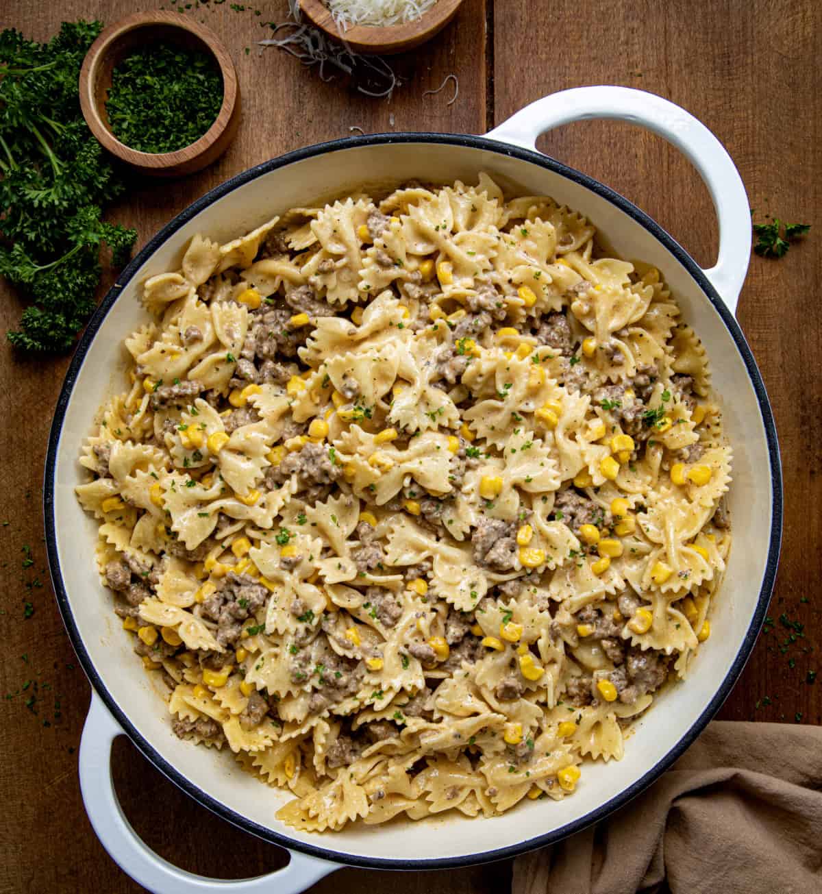 Skillet of Creamy Ranch Beef Pasta on a wooden table from overhead. 