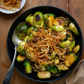 Bowl of Red Lobster Crispy Brussels Sprouts with a spoon in the bowl from overhead.