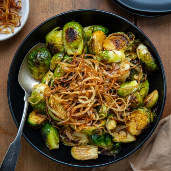 Bowl of Red Lobster Crispy Brussels Sprouts with a spoon in the bowl from overhead.