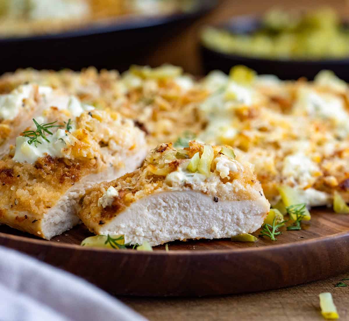 Close up of Dill Pickle Parmesan Chicken cut into pieces showing juicy chicken.