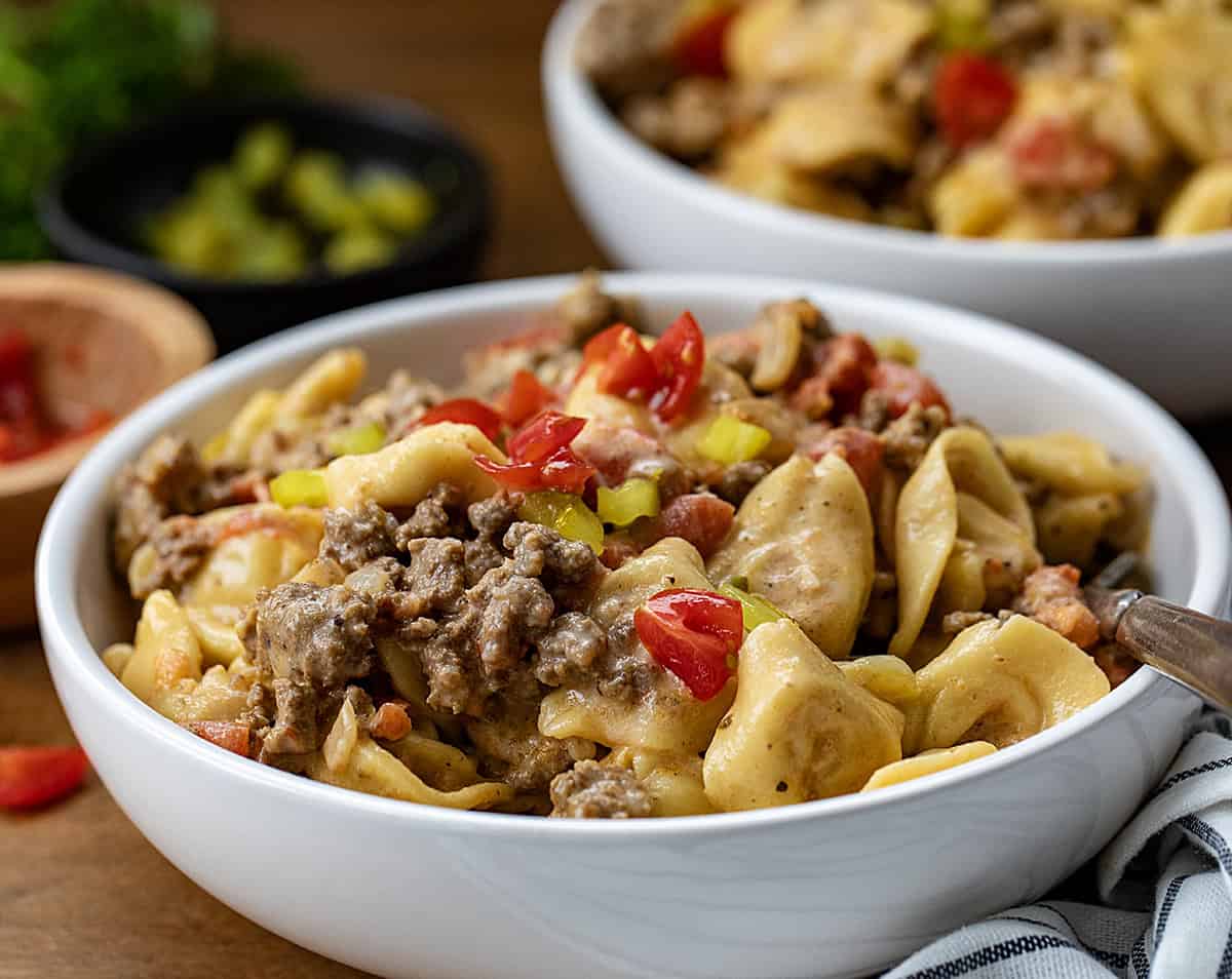 Close up of a white bowl of One Pot Cheeseburger Tortellini.