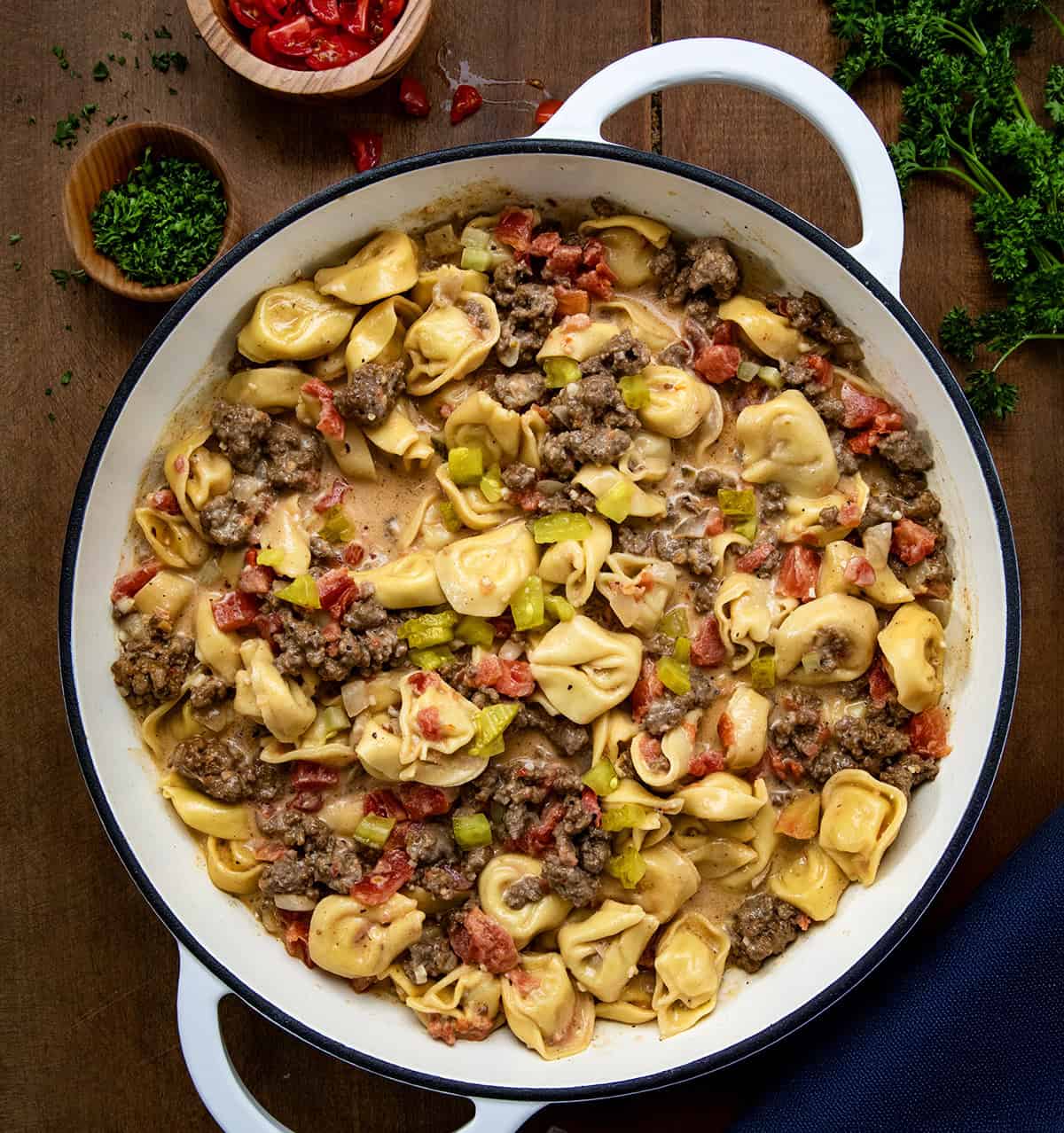 One Pot Cheeseburger Tortellini in a pot on a wooden table from overhead.