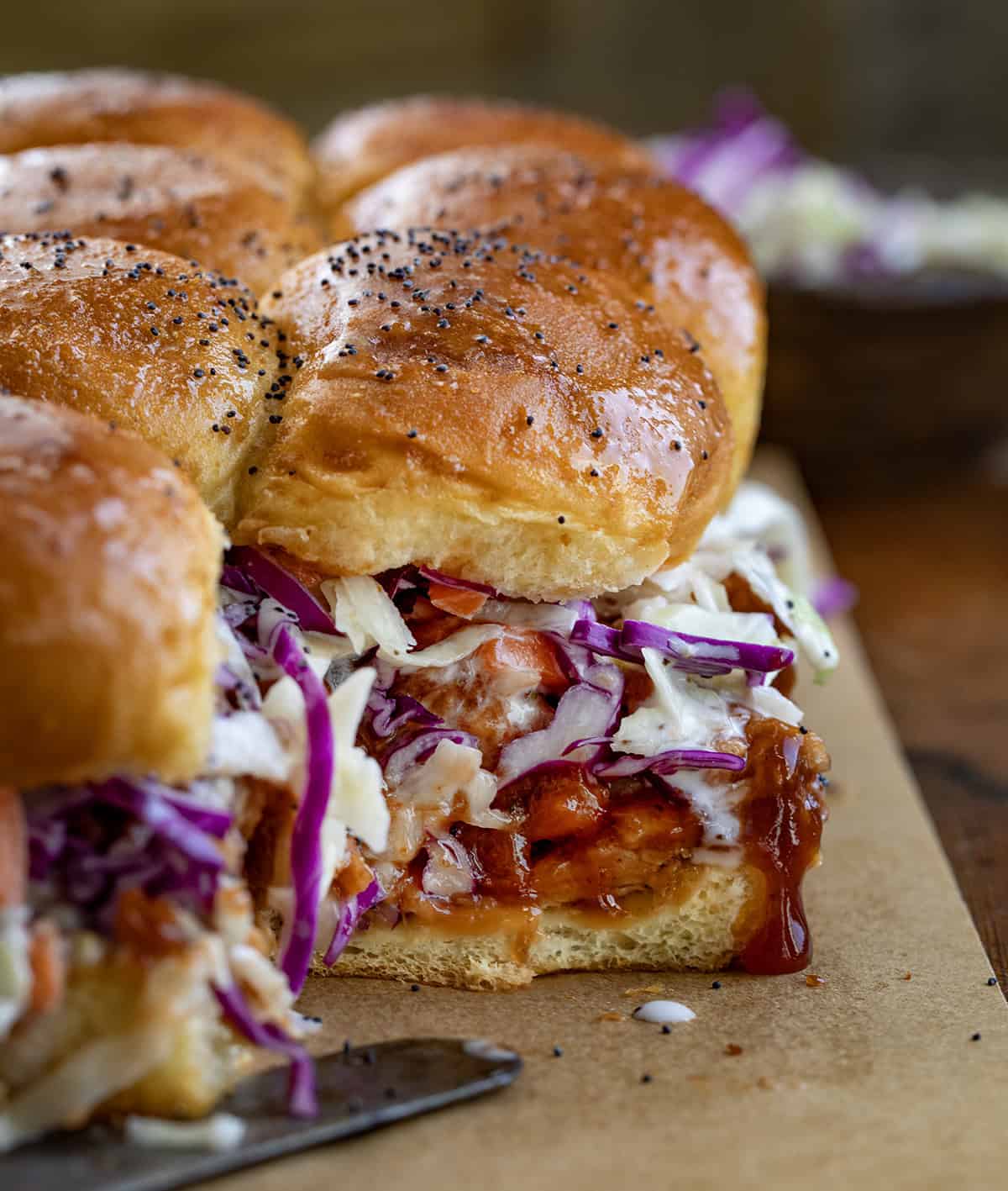 Close up of Pulled Pork Sliders with one slider removed showing inside texture.