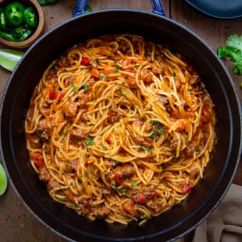 Pot of Taco Spaghetti on a wooden table.