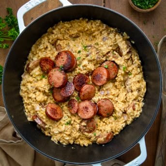 Pot of Cajun Sausage and Rice on a wooden table from overhead.