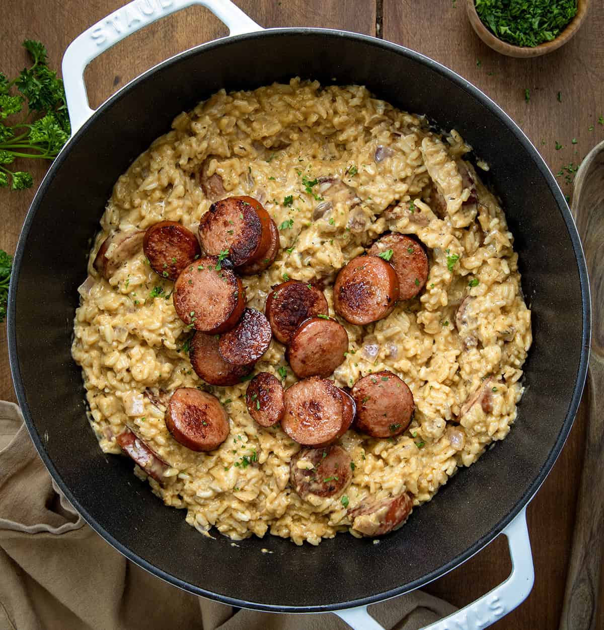 Pot of Cajun Sausage and Rice on a wooden table from overhead.
