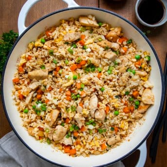 Skillet of Chicken Fried Rice on a wooden table from voerhead.