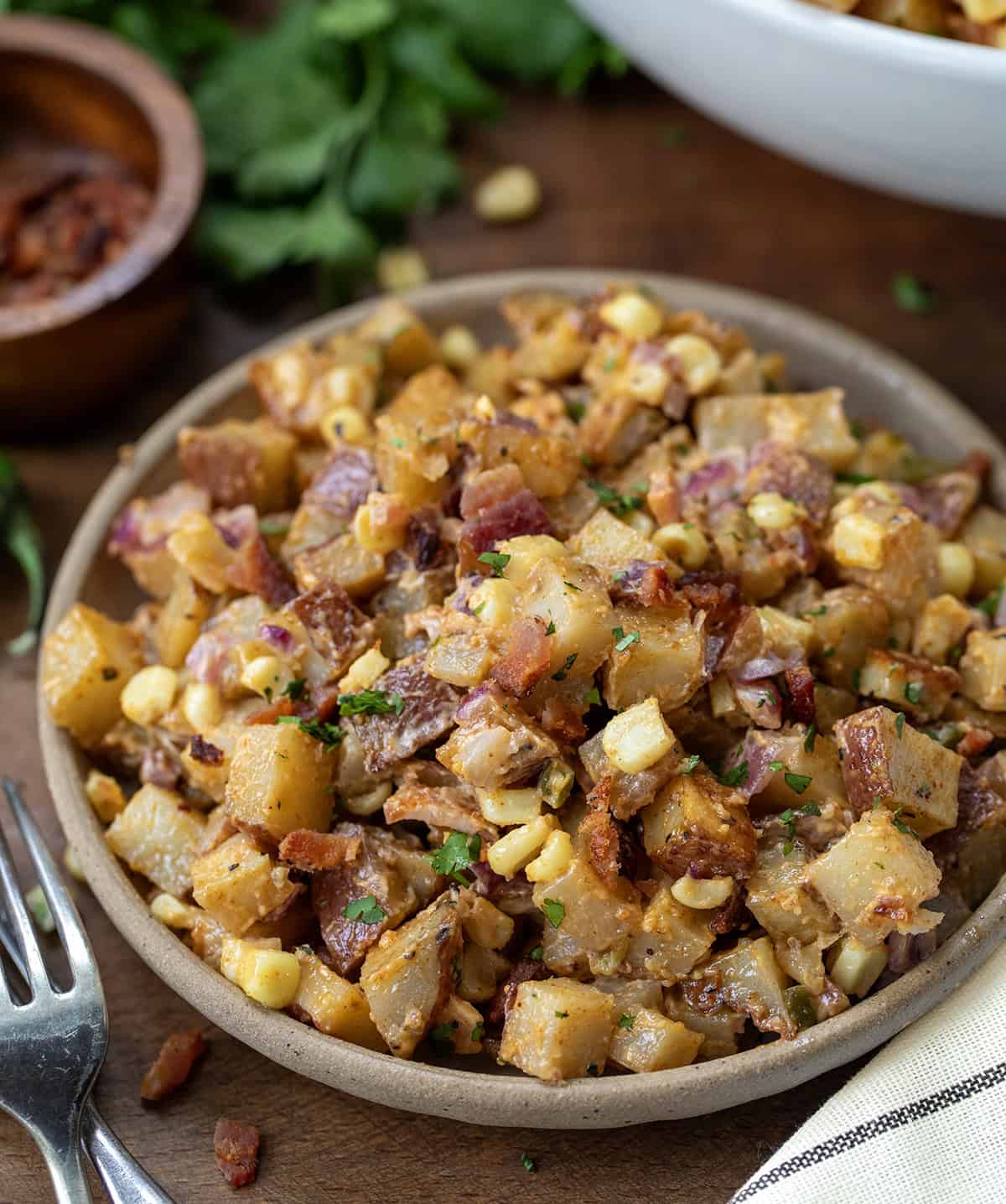 Plate of Chipotle Roasted Potato Salad on a wooden table.