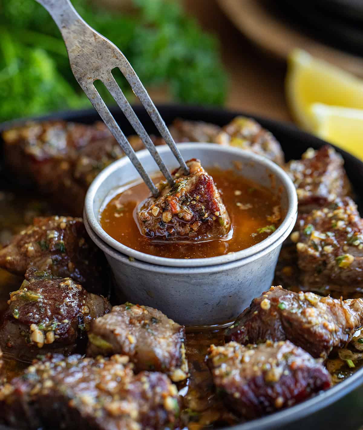 Dipping a piece of steak into cowboy butter.