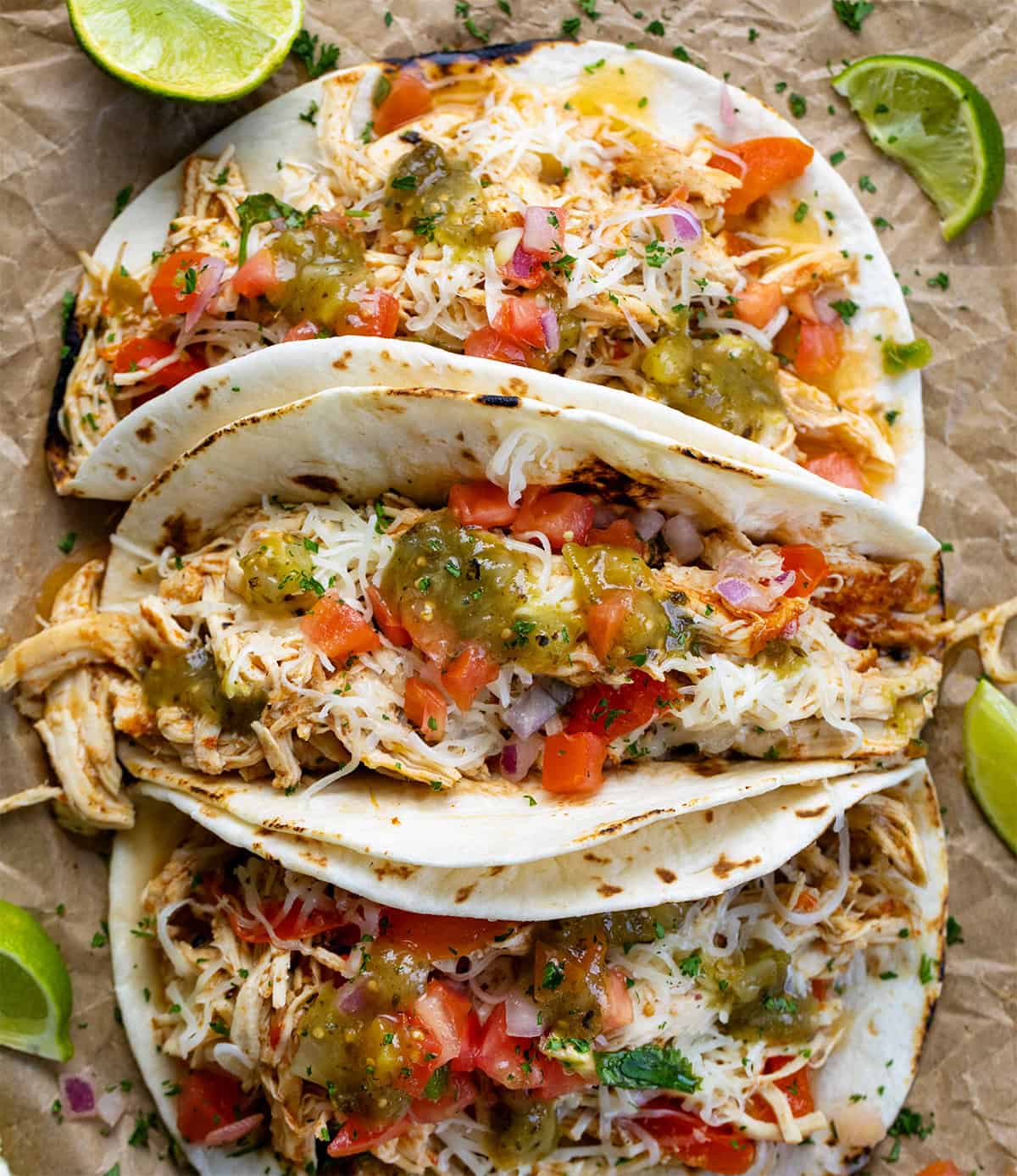 Tacos filled with Crockpot Salsa Verde Chicken from overhead.