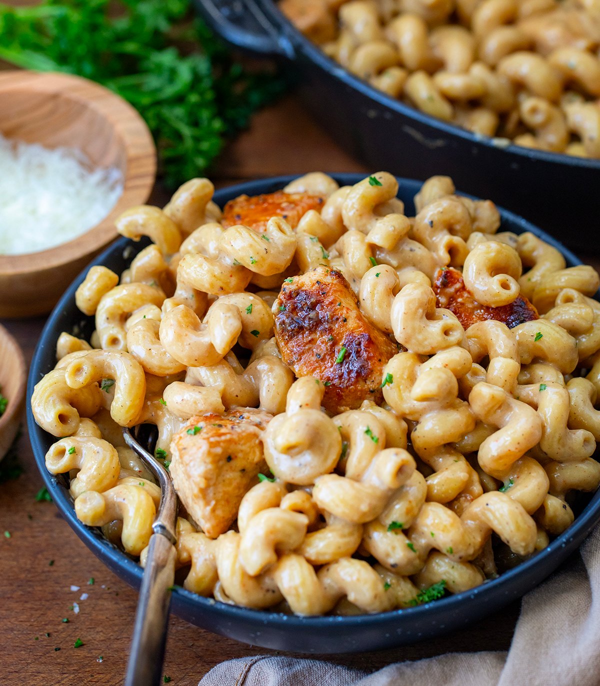 Plate of Creamy Garlic Parmesan Chicken Pasta on a wooden table.