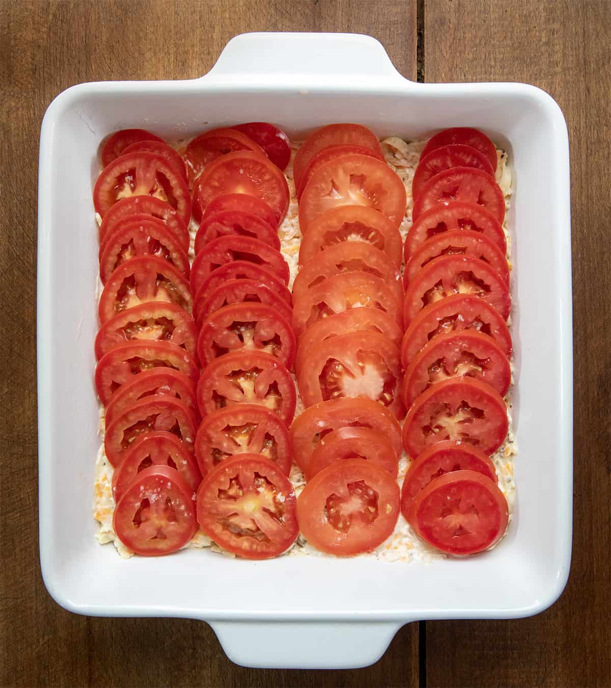 Tomatoes placed in lines similar to how a person would make scalloped potatoes.