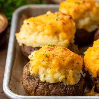 Shepherd's Pie Twice Baked Potatoes on a baking tray on a wooden table.