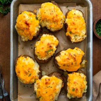 Shepherd's Pie Twice Baked Potatoes on a baking sheet on a wooden table from overhead.