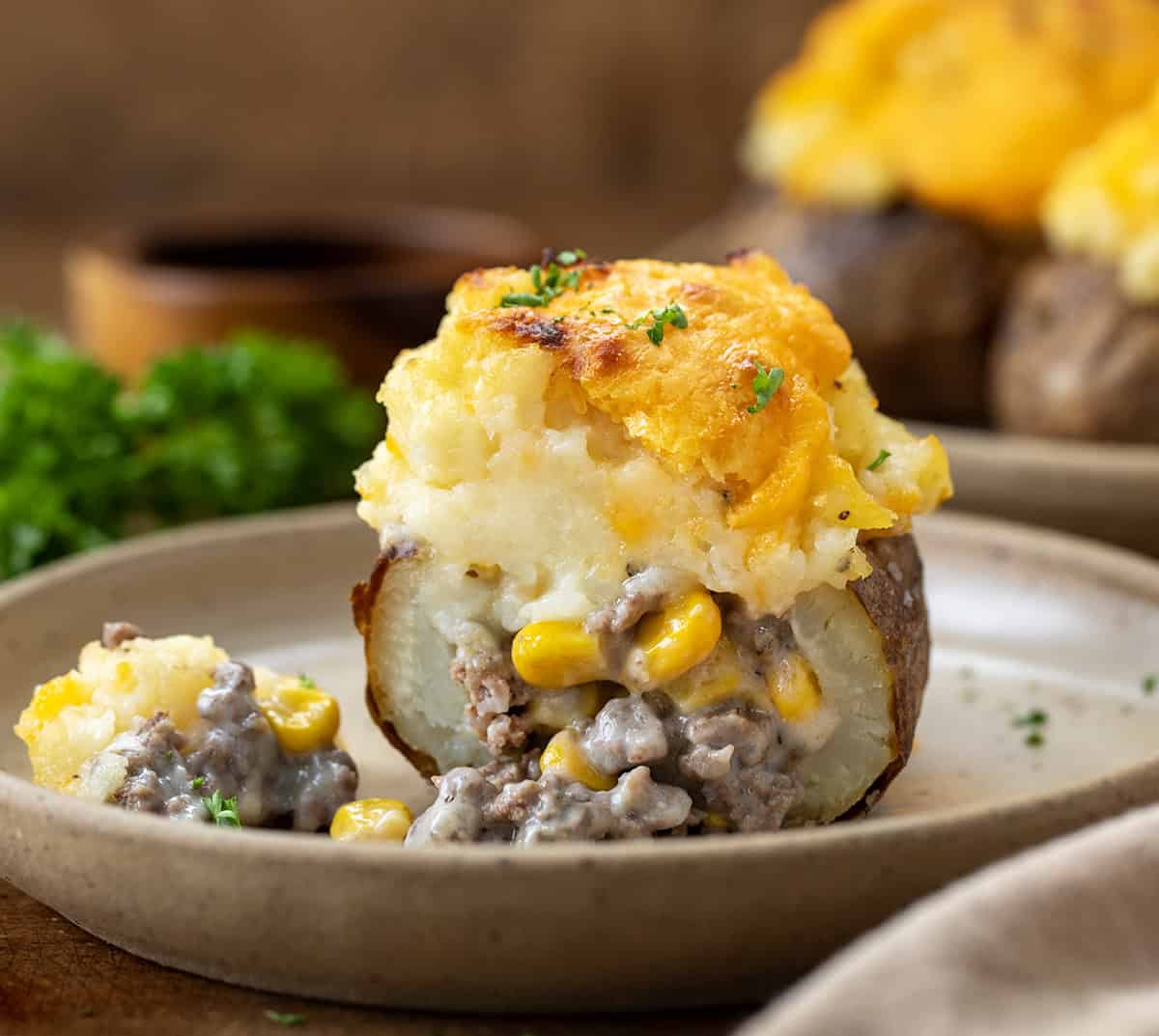 Halved Shepherd's Pie Twice Baked Potato on a plate showing filling inside.