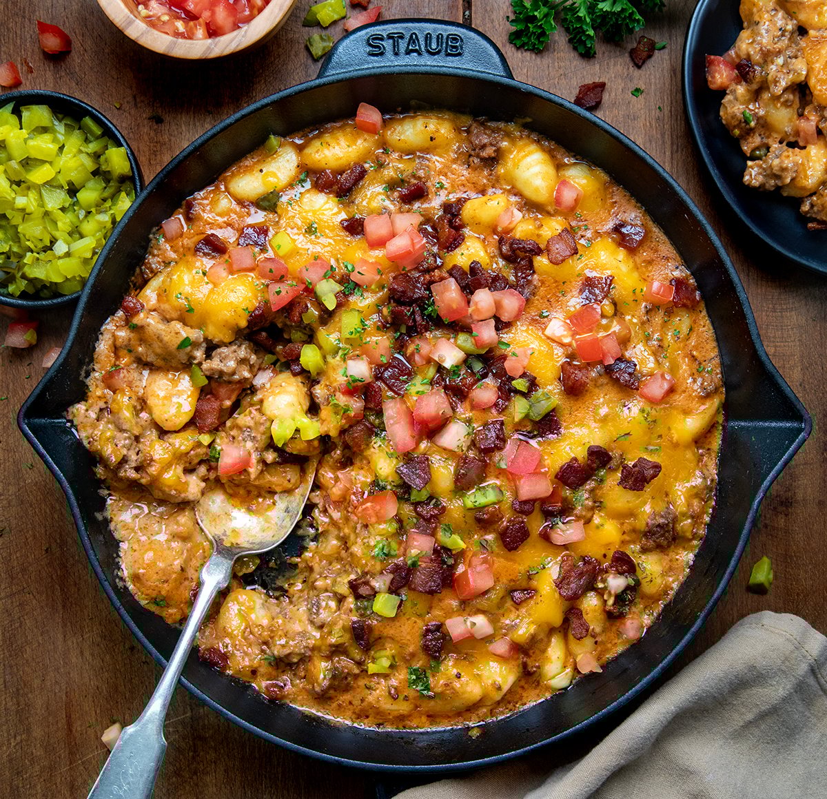 Skillet of Bacon Cheeseburger Gnocchi with a spoon in it from overhead.