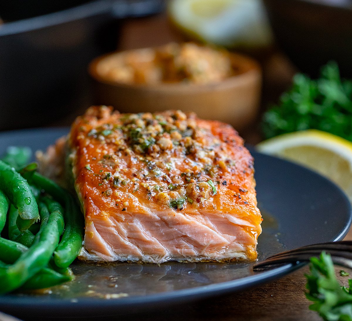 Piece of Cowboy Butter Salmon with a bite removed showing flakey salmon.
