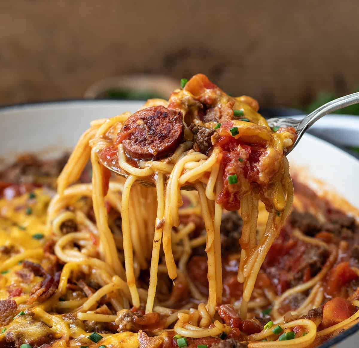 Spoon picking up a portion of One Pot Cowboy Spaghetti from the pot.