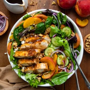 Family size bowl of Roasted Peach Chicken Salad on a wooden table from overhead.