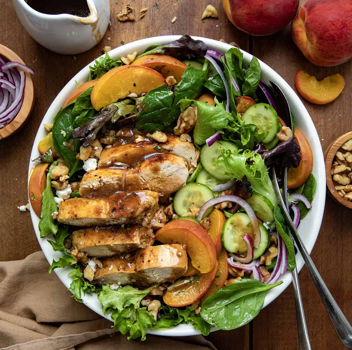 Family size bowl of Roasted Peach Chicken Salad on a wooden table from overhead.