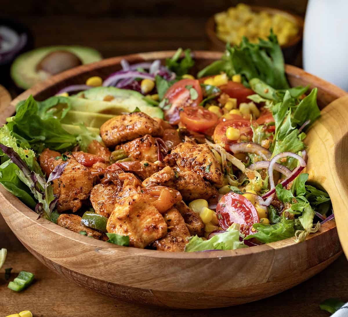 Close up of the hot roasted peach and chicken bites in a salad.