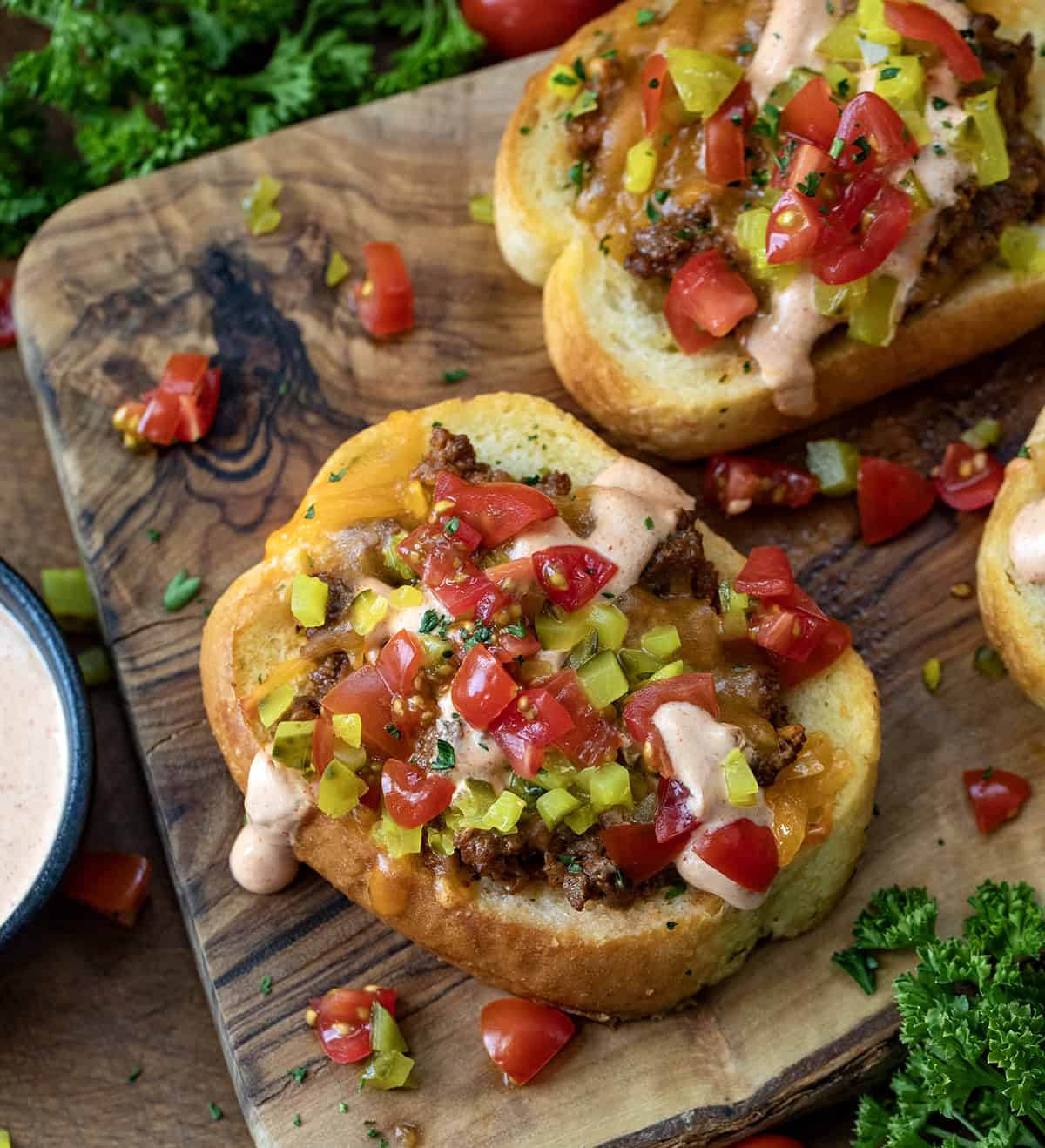 Pieces of Cheeseburger Garlic Bread on a cutting board.