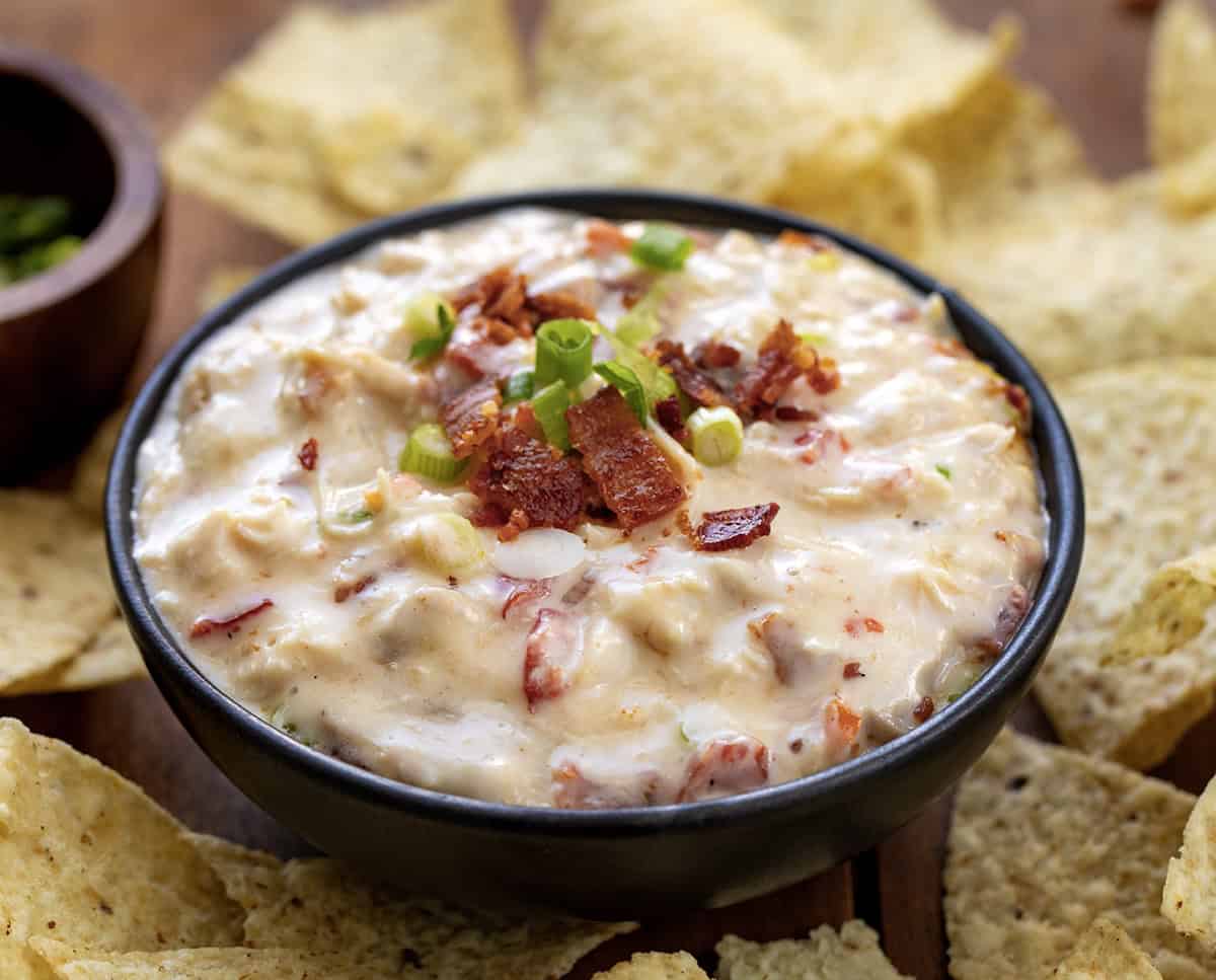 Bowl of Chicken Bacon Ranch Queso surrounded by chips.