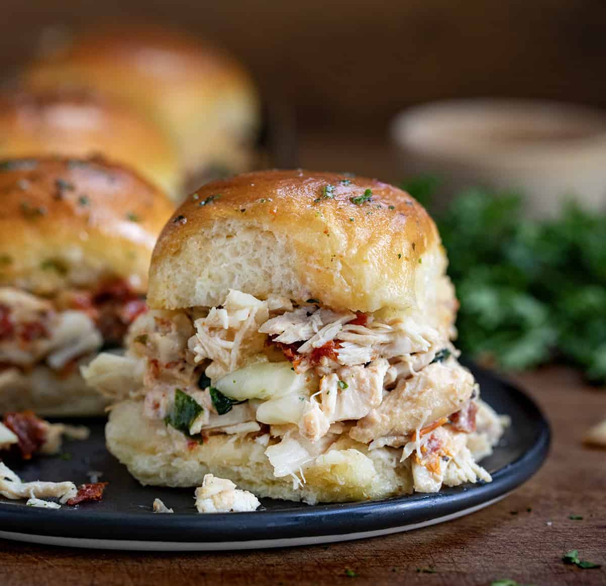 Close up of a Marry Me Chicken Slider on a black plate.