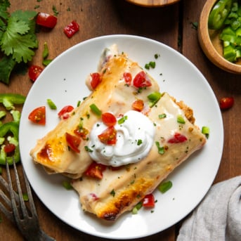 Cut Queso Enchiladas on a white plate from overhead.