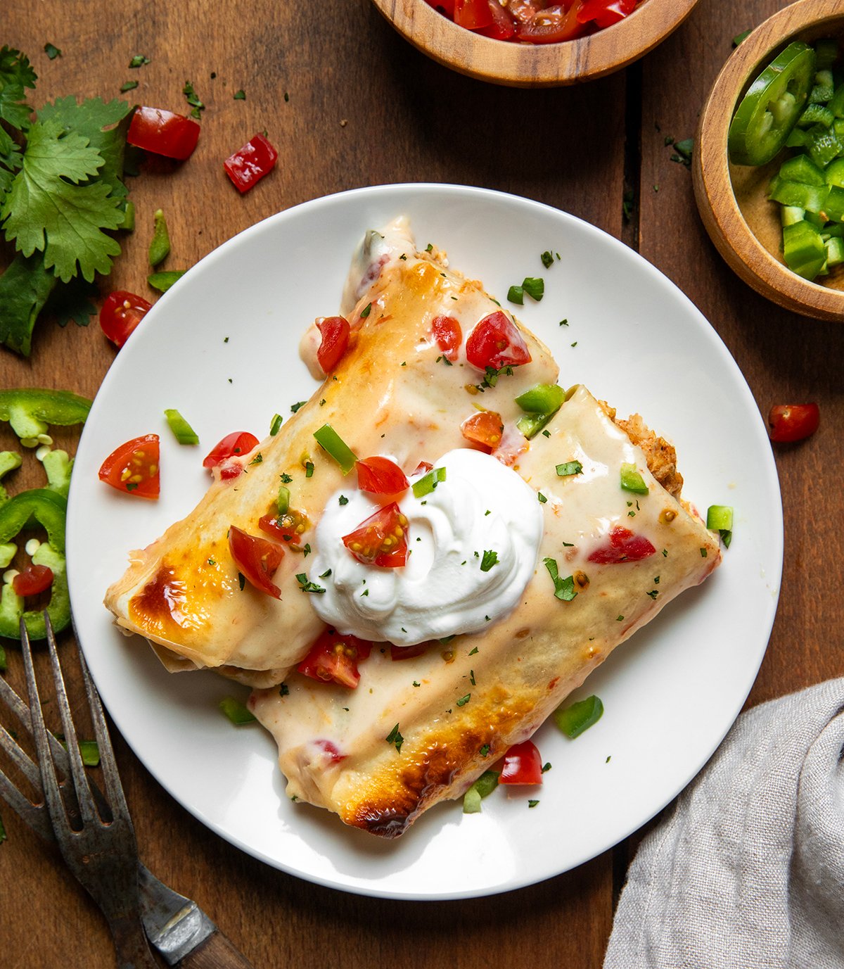 Cut Queso Enchiladas on a white plate from overhead.