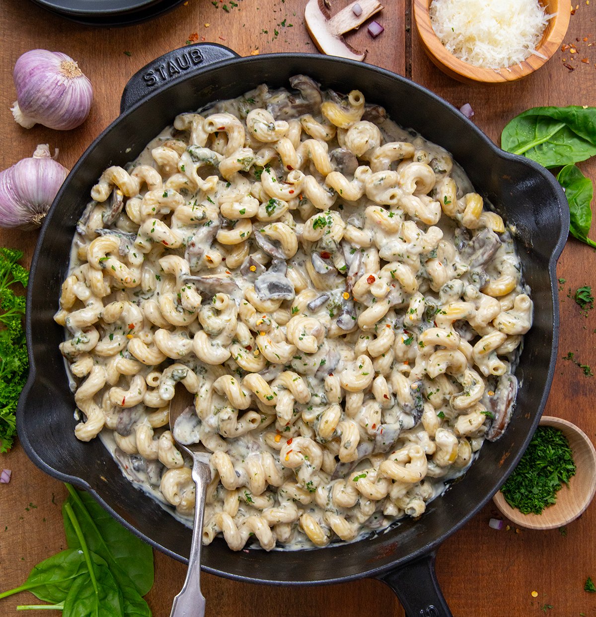 Roasted Garlic Mushroom Pasta in a skillet on a wooden table from overhead. 