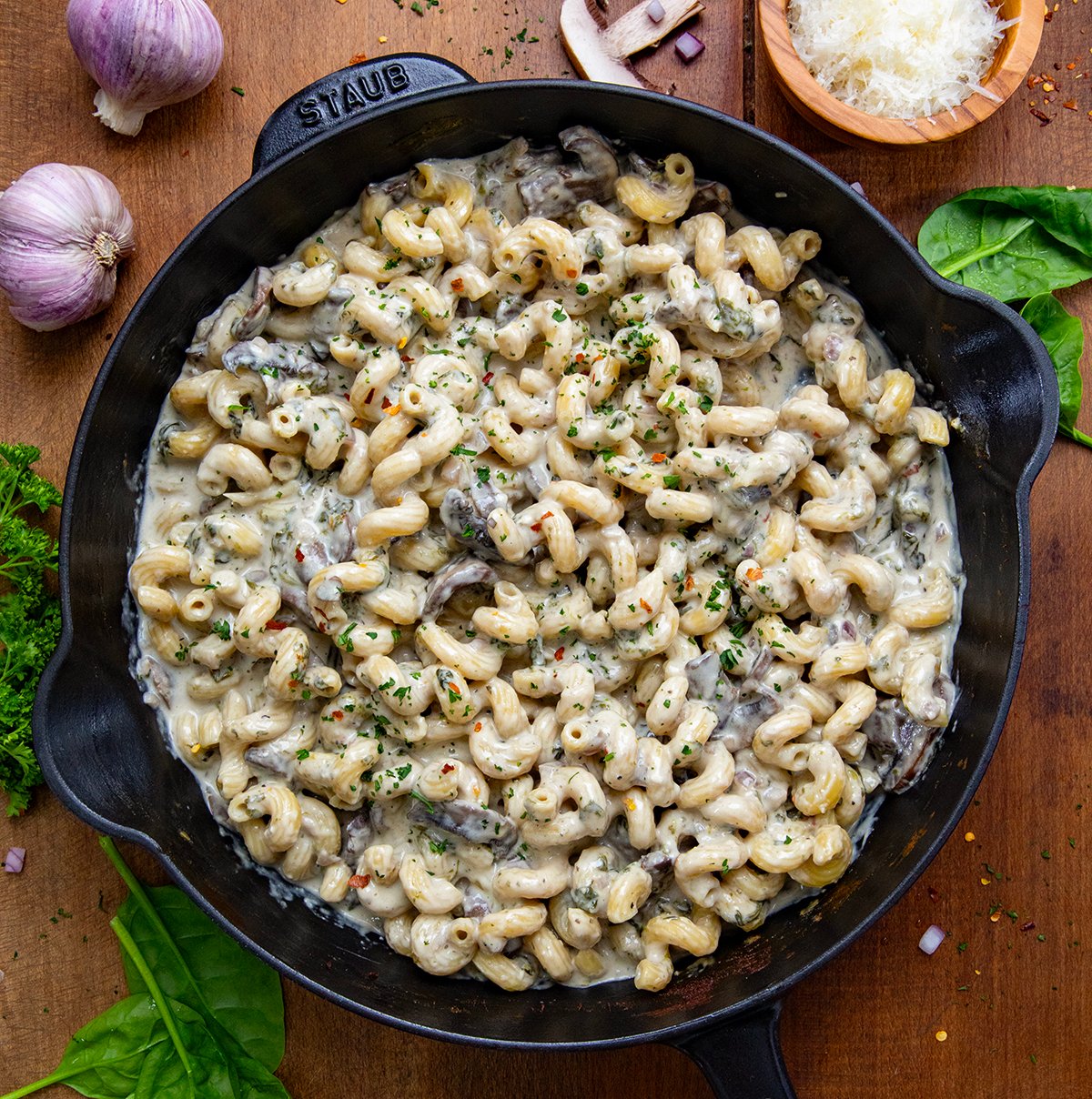 Roasted Garlic Mushroom Pasta in a skillet on a wooden table from overhead.