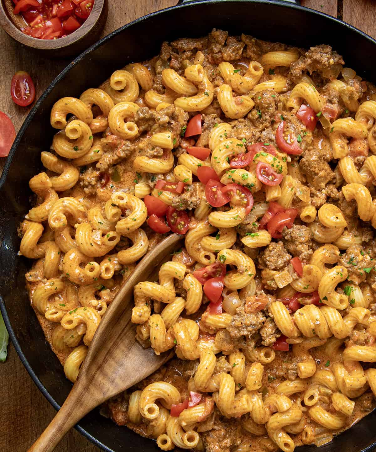 Close up of Rotel Pasta Fiesta in a skilelt with a wooden spoon.