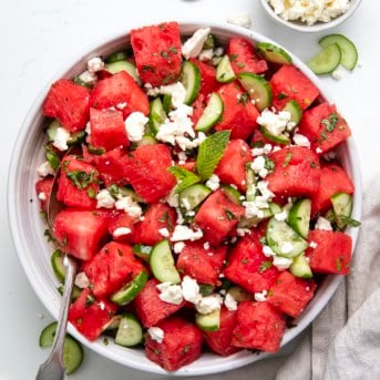 Watermelon Feta Salad in a white bowl on a white table from overhead.
