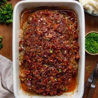Bacon Jam Meatloaf in a white pan on a wooden table from overhead.
